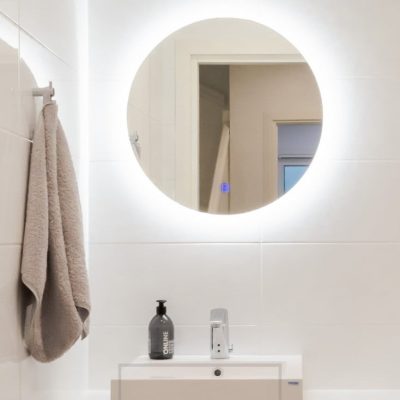 Pyöreä valopeili kylpyhuoneessa valaisee seinän kautta sekä huurteen läpi kohti kasvoja. Ledstore.fi