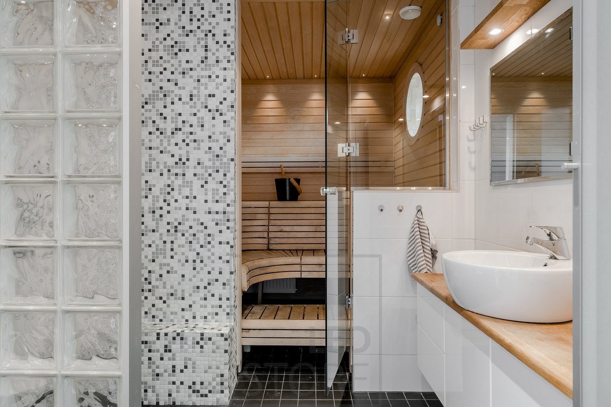 Creative and versatile sauna lighting — in this sauna, small spotlights have been used in the ceiling near the wall edge of the steam room.
